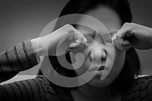 Asian woman rubbing her eyes by two hands. Concept of  eye`s problem, dust allergy, dry eye, watery, itching or contact lenses