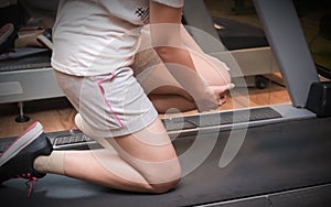 Asian woman runner got sports injury on machine treadmill at fitness gym