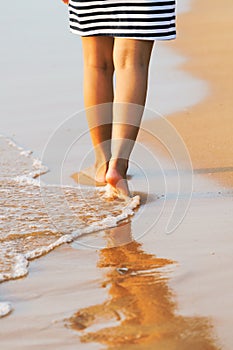 Asian Woman`s legs walking on Pattaya sand beach Thailand