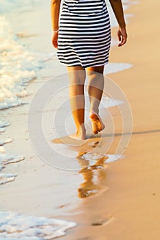 Asian Woman`s legs walking on Pattaya sand beach Thailand