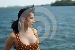Asian Woman 40s LGBT transgender express feeling lonely alone sad under sunshine on water river