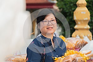 Woman hold the monk robe in ordination ceremony