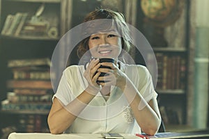 Asian woman 50s year old toothy smiling face white beverage cup photo