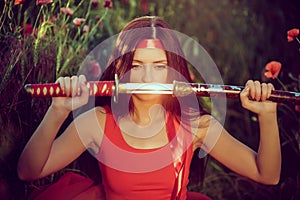 Asian woman with samurai sword on the nature