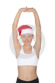 Asian woman in Santa`s hat engaged in fitness