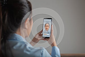 Asian woman scanning face with facial recognition system on smartphone for verify identity, Verify your identity, Biometric