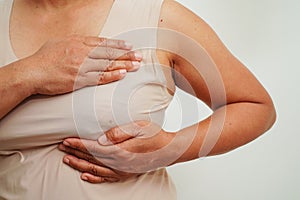 Asian woman self touching check lump or Breast cancer, Breast Self Exam