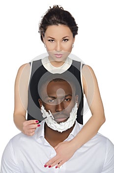 Asian woman shaves dark-skinned men razor