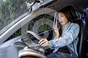 Asian woman shocked and shouting while driving on the road She was involved in a car accident