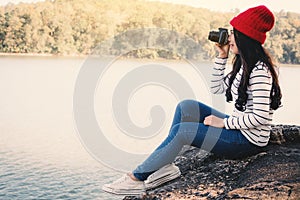 Asian woman shooting picture in nature