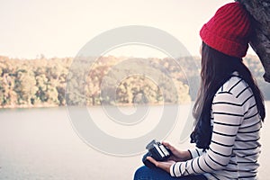 Asian woman shooting picture in nature