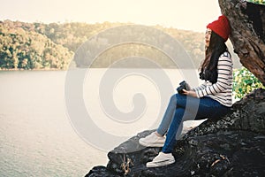 Asian woman shooting picture in nature