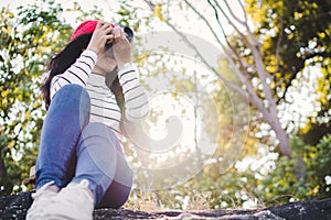 Asian woman shooting picture in nature