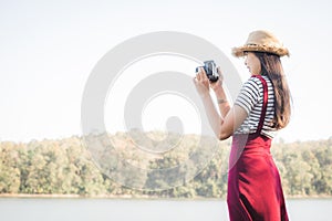 Asian woman shooting picture in nature