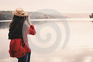 Asian woman shooting picture in nature