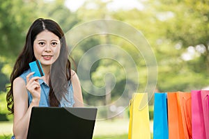 Asian woman shopping online with credit card