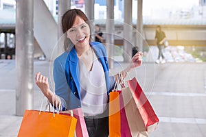 Asian woman shopping smile and holding shopping bag with shoppi