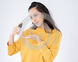 Asian woman showing bottle alcohol antiseptic gel for washing hands with hand sanitizer.