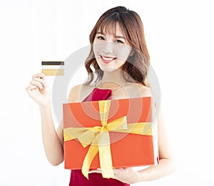 Asian woman showing credit card and gift