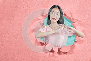 Asian woman showing heart shape with hands