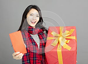 Asian woman showing red envelopes and gift for chinese new year