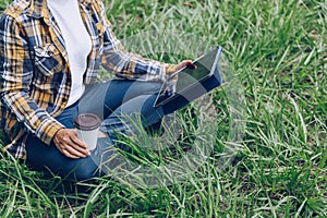 Asian woman sitting and drinking coffee in the garden