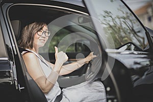 Asian woman sitting on driver seat in suv car sigh good tumb