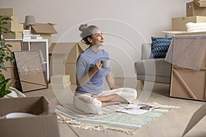 Asian woman sitting and resting in new house after moving in