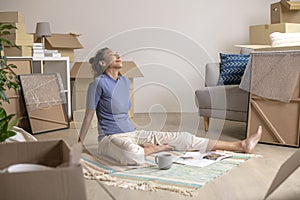 Asian woman sitting and resting in new house after moving in