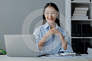Asian woman sitting in startup company office, businesswoman, executive and investor in business and stocks, management of young
