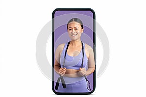Asian woman with skipping rope on large smartphone screen, lady smiling at camera