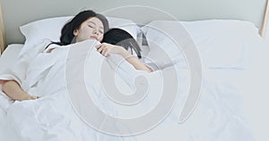 Asian woman sleep restless on bed in the bedroom.
