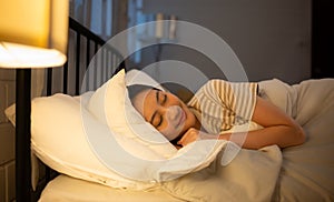 Asian woman sleeping on the bed in her bedroom at home