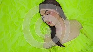 Asian woman sleeping in the green dress while wearing makeup