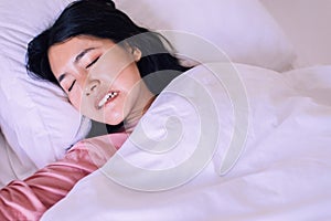 Asian woman sleeping and grinding teeth in bedroom,Female tiredness and stress photo