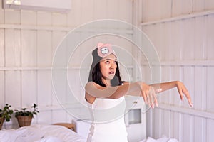 Asian woman sleepwalker with somnambulism sleep and walking in bedroom photo