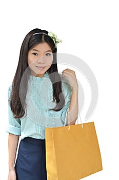 Asian woman smiling and holding shopping bag