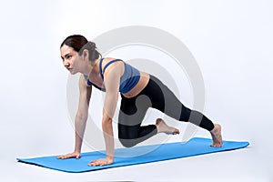 Asian woman in sportswear doing burpee on exercising mat. Vigorous