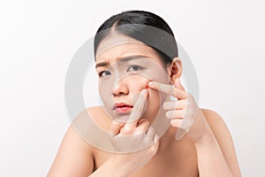 Asian woman squeezing pimples on her face, skin care lifestyle concept.