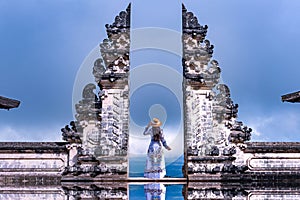 Asian woman standing in Bali gate, Pura Luhur Lempuyang temple Bali, Indonesia