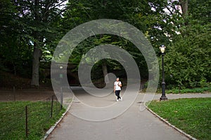 Asian Woman standing by Glade Arch in Central Park