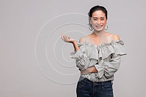 Asian woman standing and point her finger