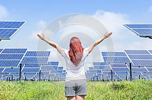 Asian woman standing raised up arms celebrate achievements freedom success in solar cell power station.