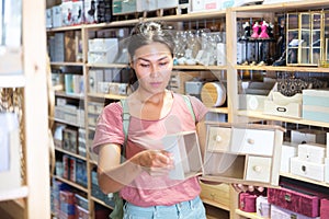 Woman with wooden sundries storage box in store photo