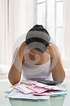 Asian woman stress over bills