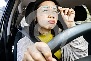 Asian Woman Struggles to Drive with Blurry Vision and Prohibited Eyeglasses