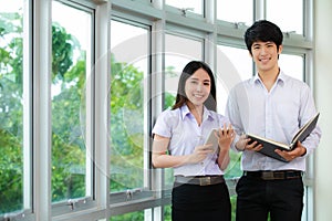 Asian woman student read text book in her university library