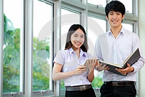 Asian woman student read text book in her university library