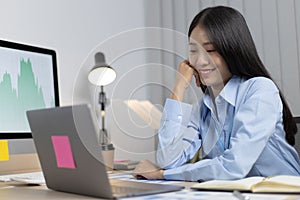 Asian woman is studying online via the internet with a cheerful smile, stay home, New normal