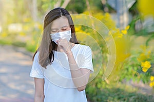 Asian woman suffer from cough with face mask protection